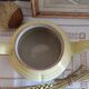 Old yellow earthenware teapot