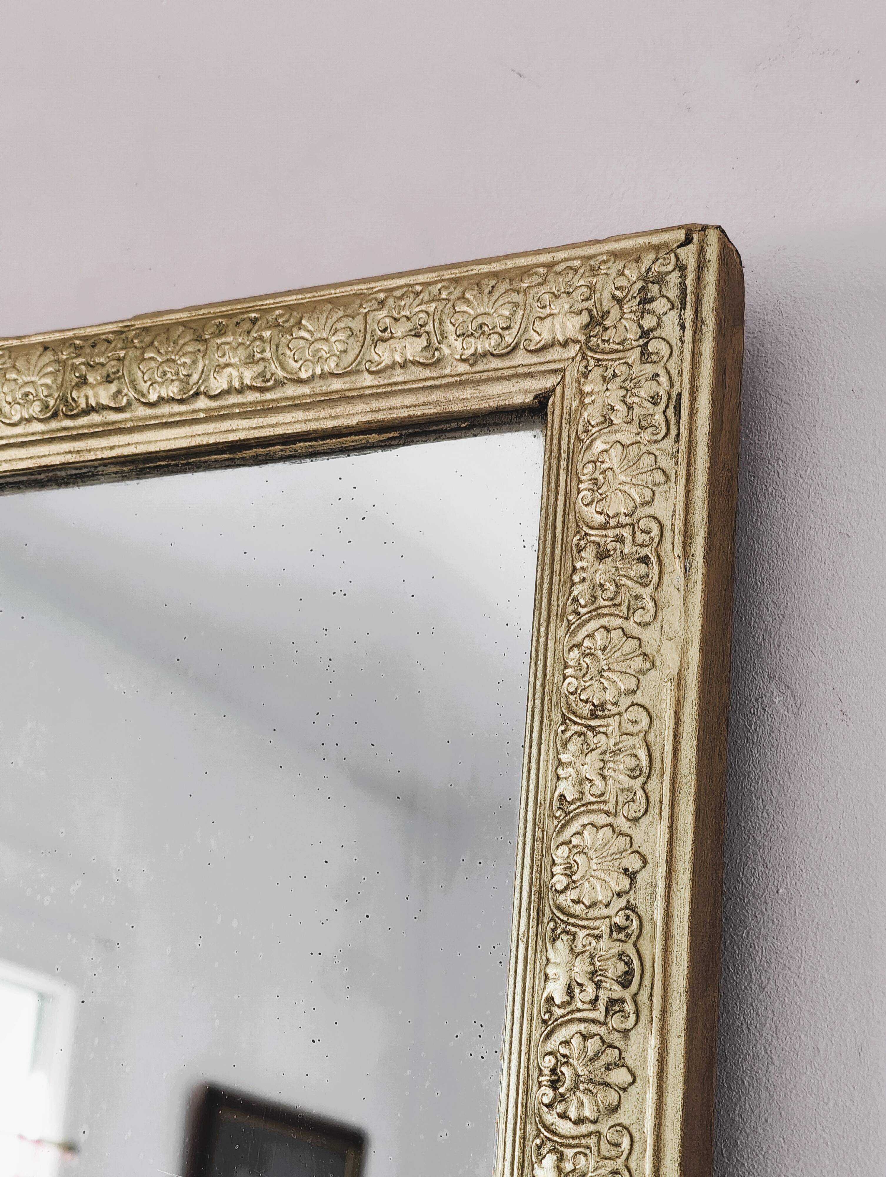 Rectangular wooden mirror with ornate Art Nouveau gold finish.