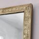Rectangular wooden mirror with ornate Art Nouveau gold finish.