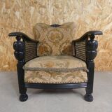 Old armchair upholstered in velvet, carved and caned wood