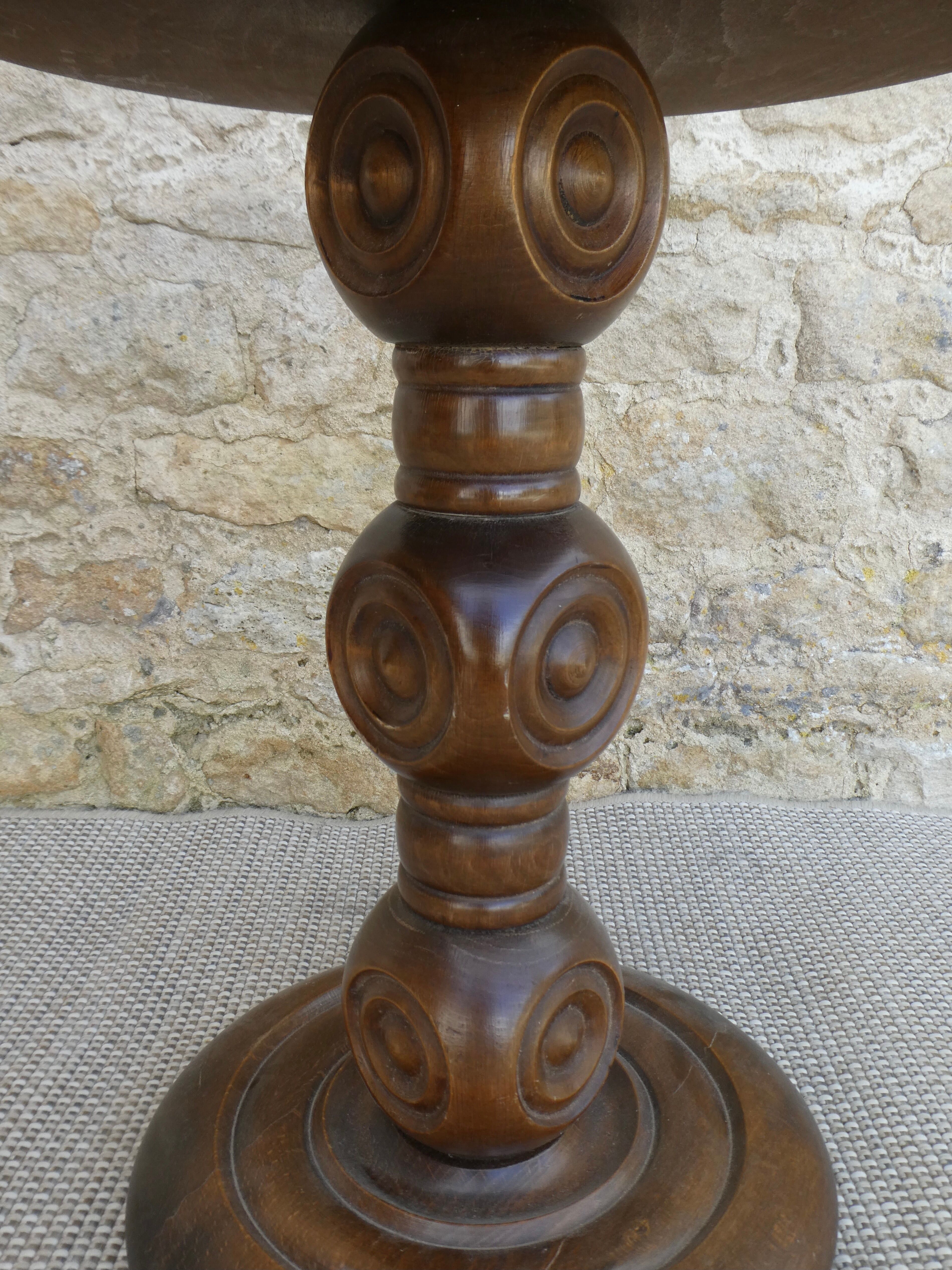 Pedestal table on carved wooden base