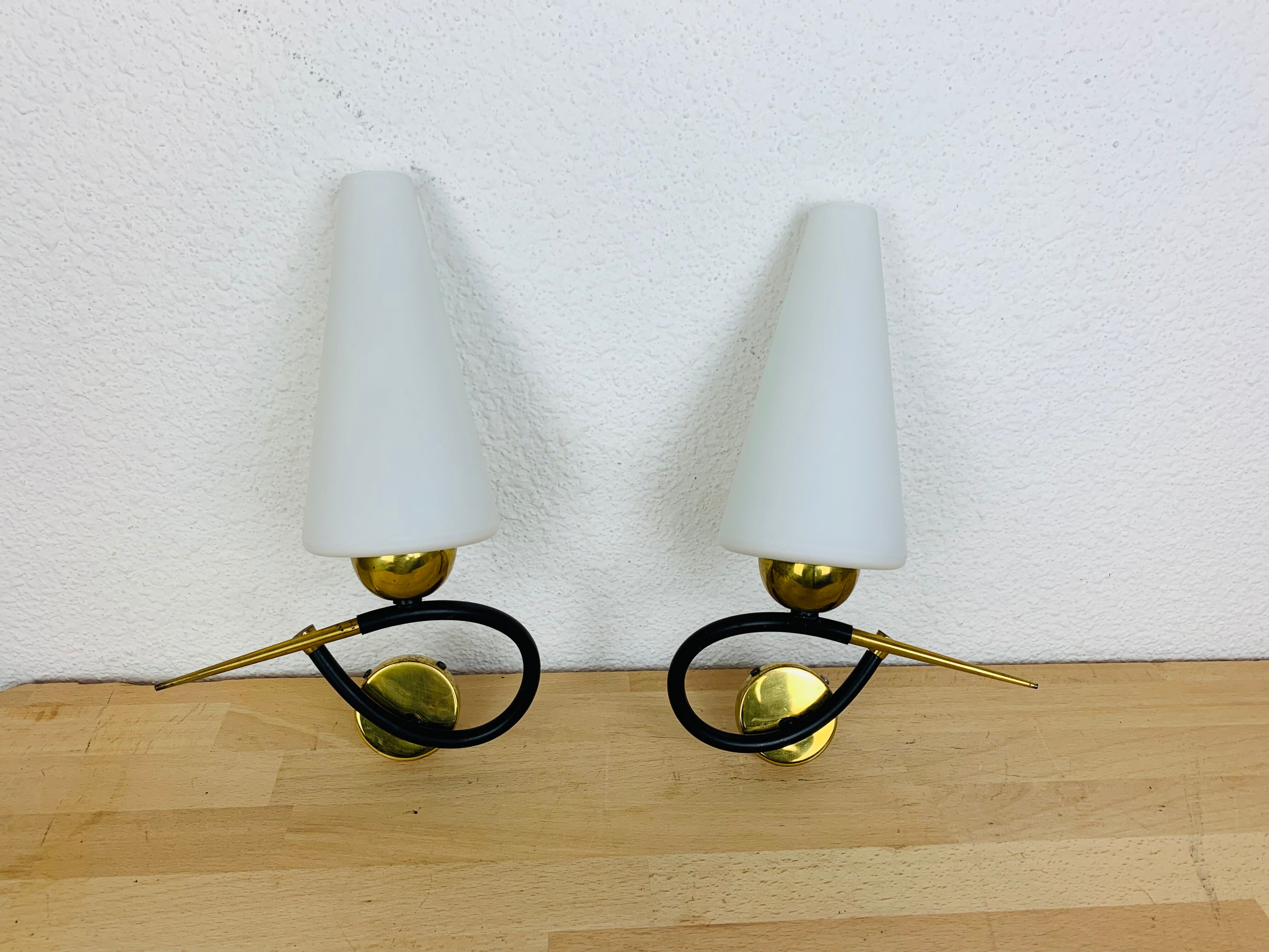 Pair of Arlus 50s opaline black and golden brass wall lamps