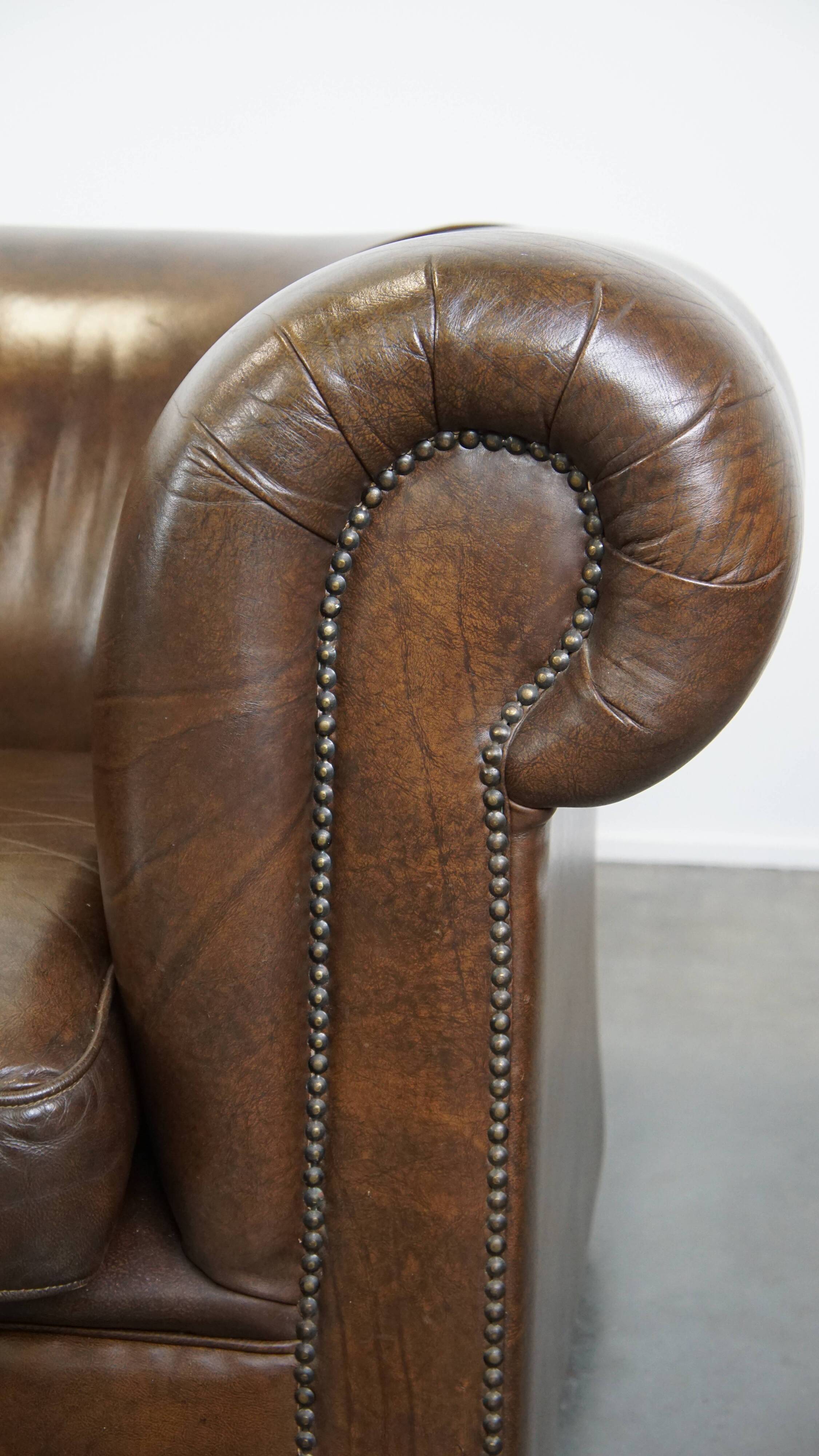 2 Chesterfield armchairs in dark brown cowhide