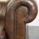 2 Chesterfield armchairs in dark brown cowhide