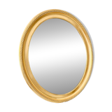 Oval wall mirror in gilded wood