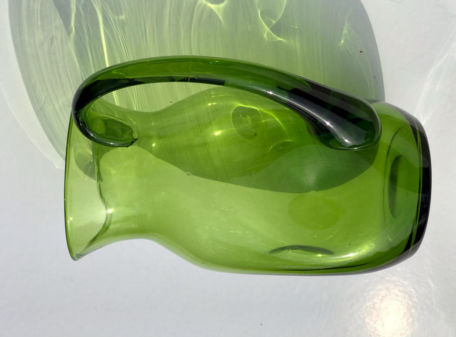 Green water jug in blown glass