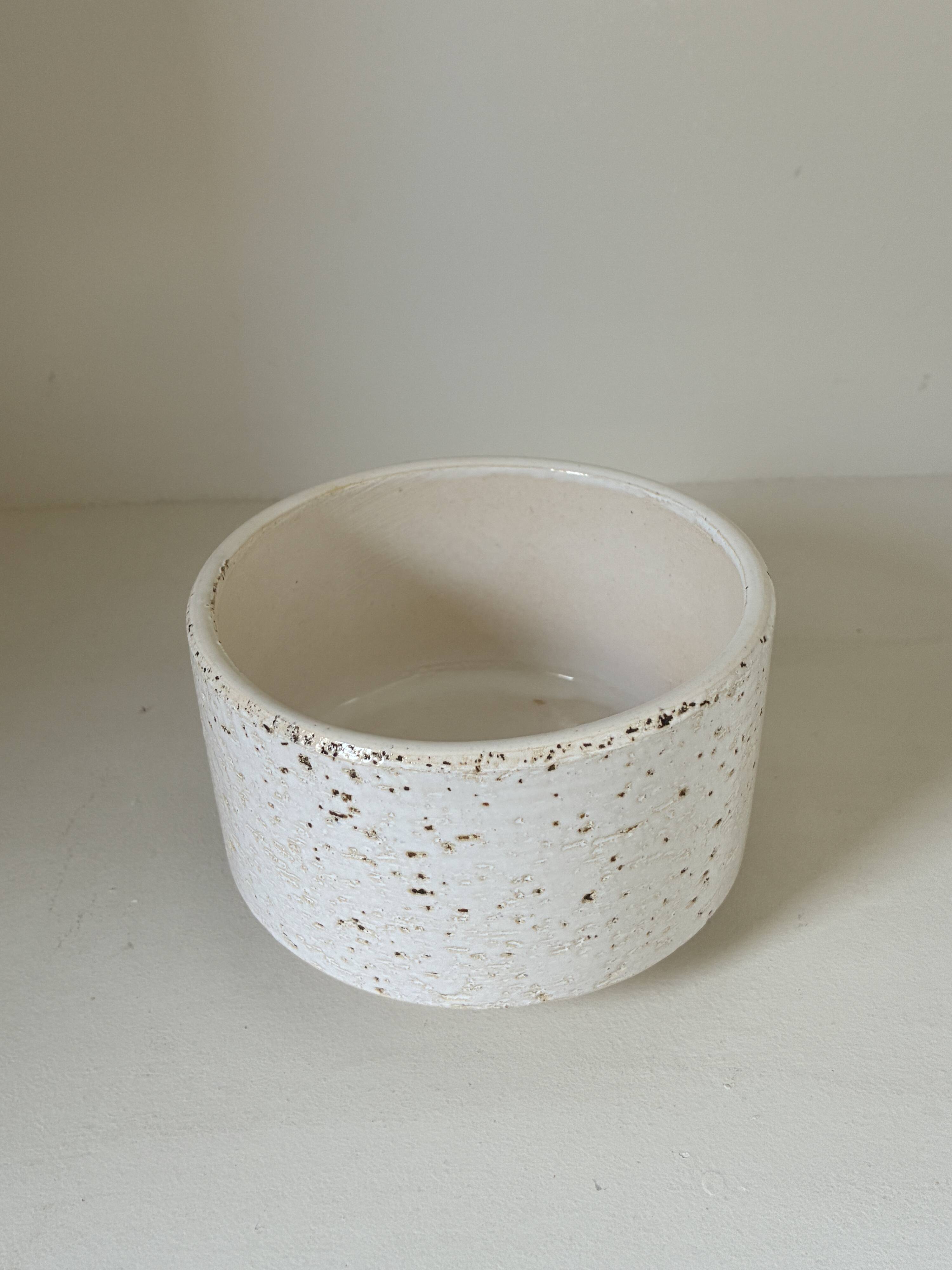 White ceramic vase with a textured effect.