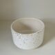 White ceramic vase with a textured effect.