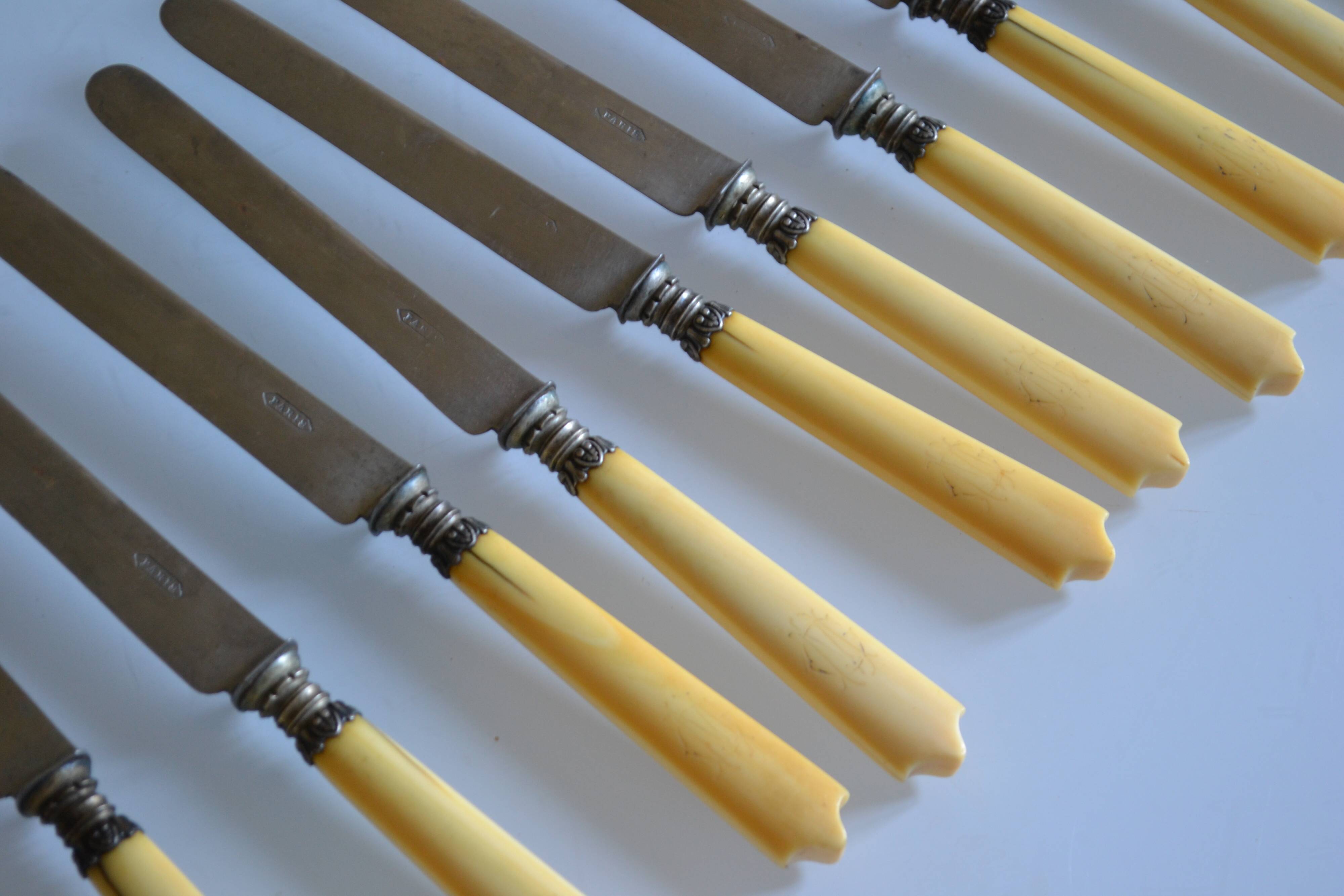 11 antique dessert knives from the 19th century with ivory-colored handles and a monogram