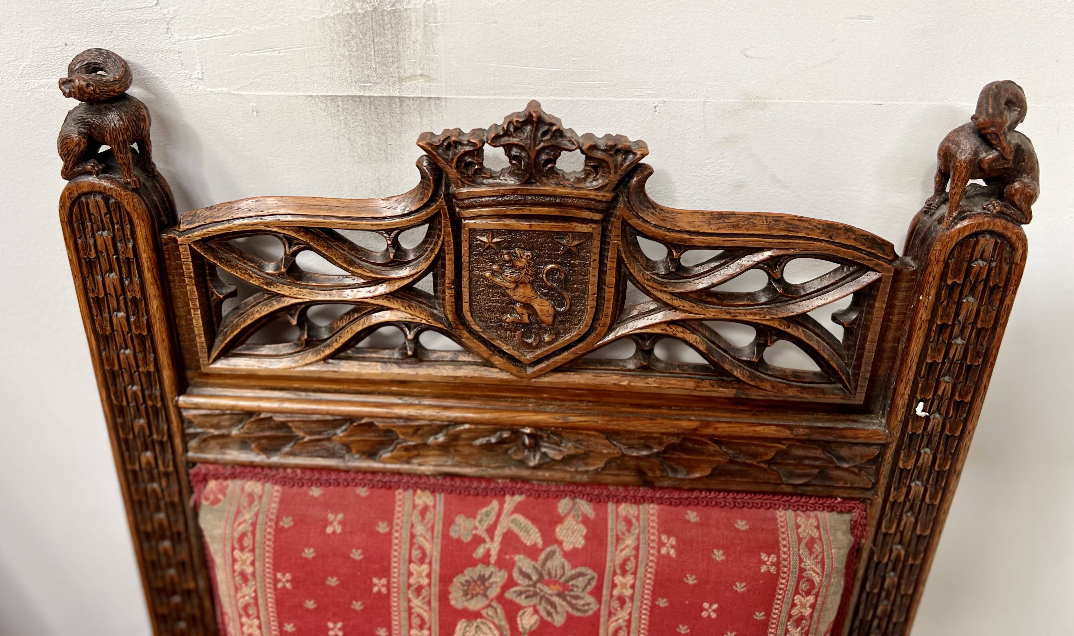 Pair of Gothic-style walnut lounge chairs, 19th century