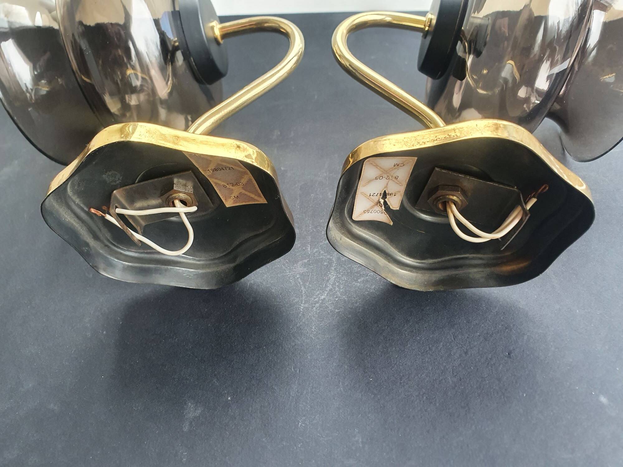 Pair of antique gold-plated brass and smoked glass wall lights.