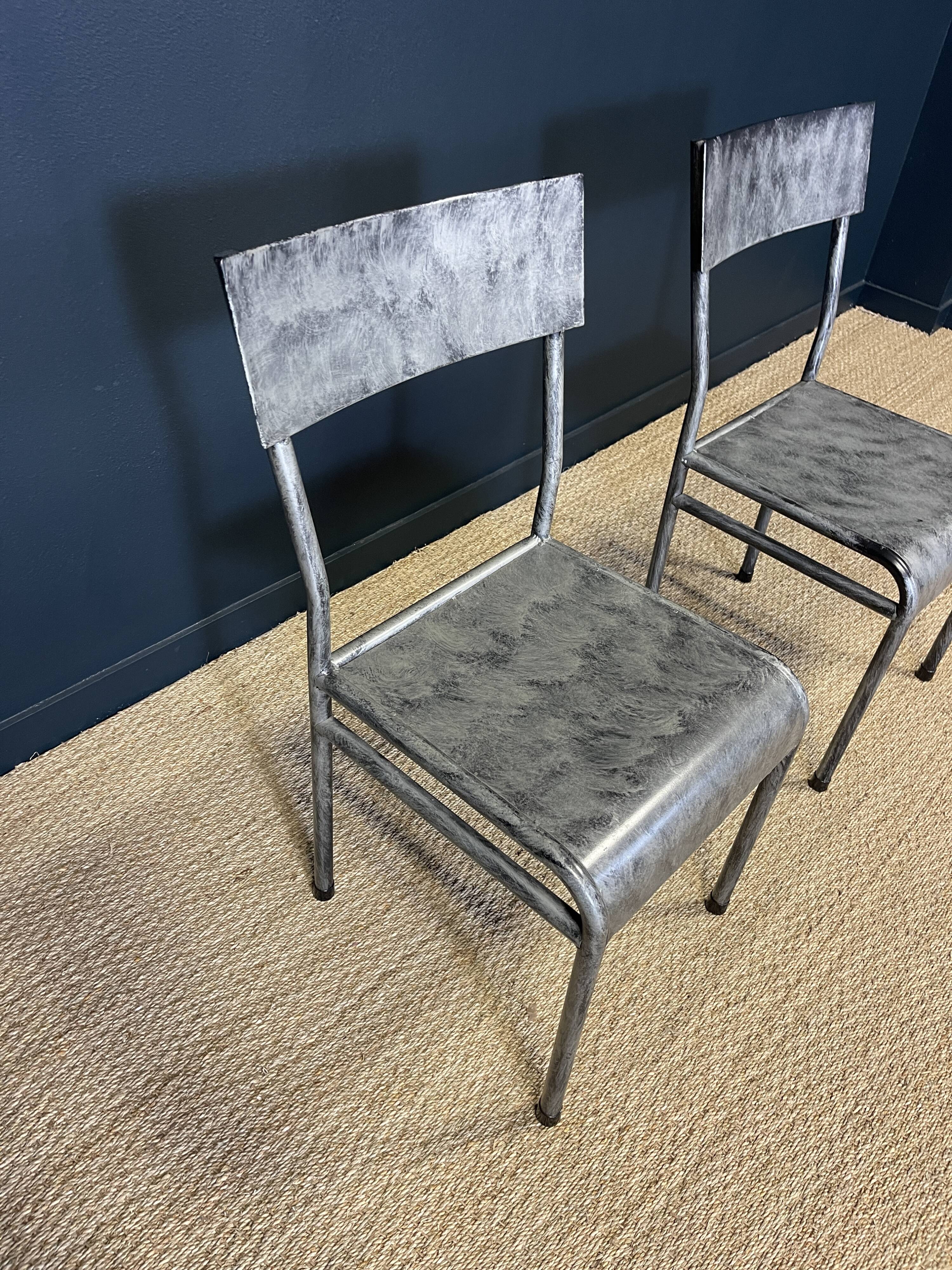 Pair of gray metal industrial chairs