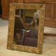 19th-century mirror in wood and stucco with floral decoration.