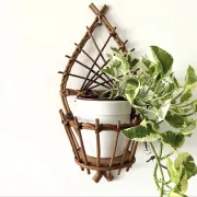 Wall-mounted plant holder in rattan