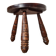 Small brutalist tripod stool made of turned wood.