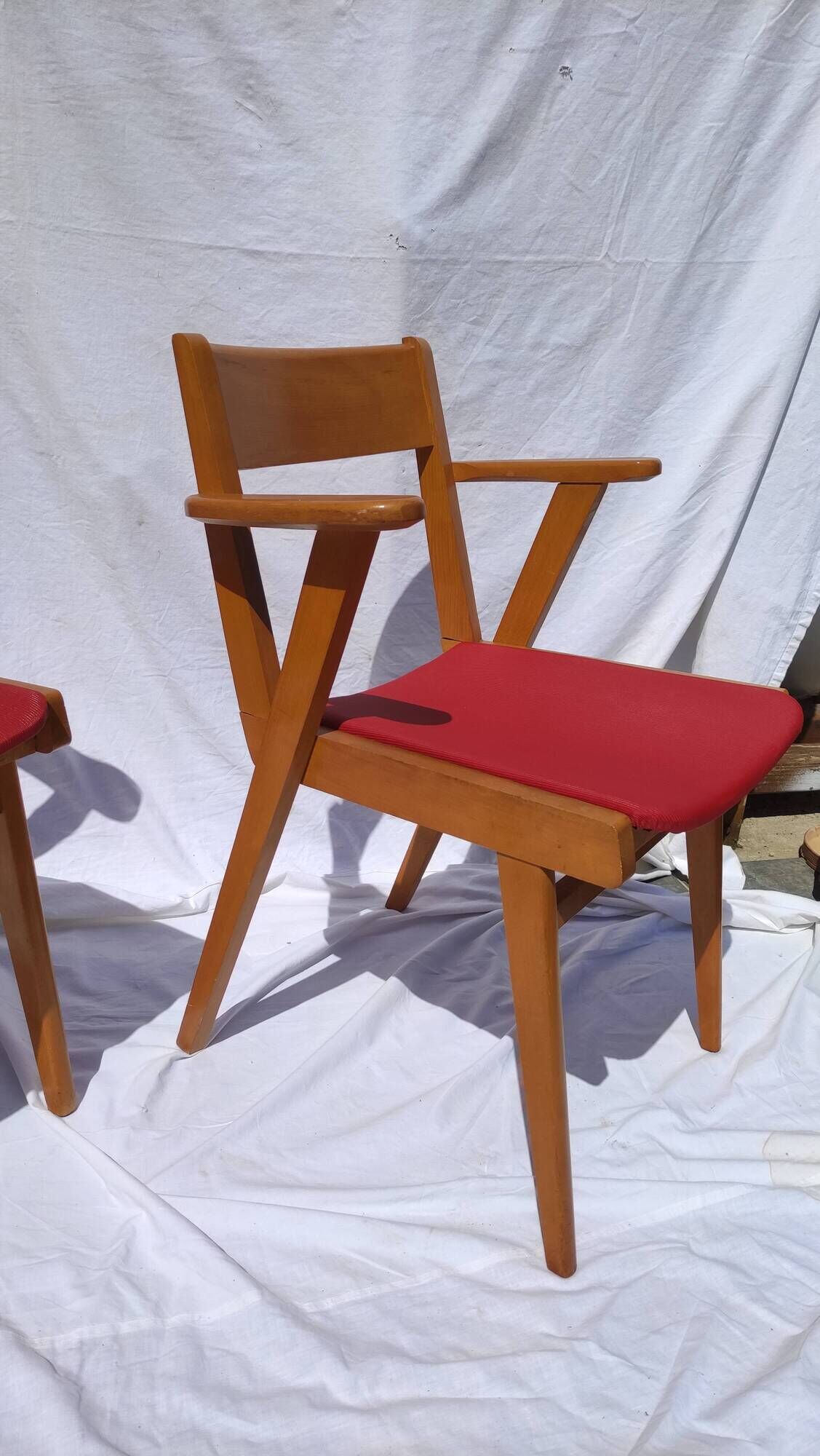 Pair of wooden armchairs and skaï foot compass of the 50s