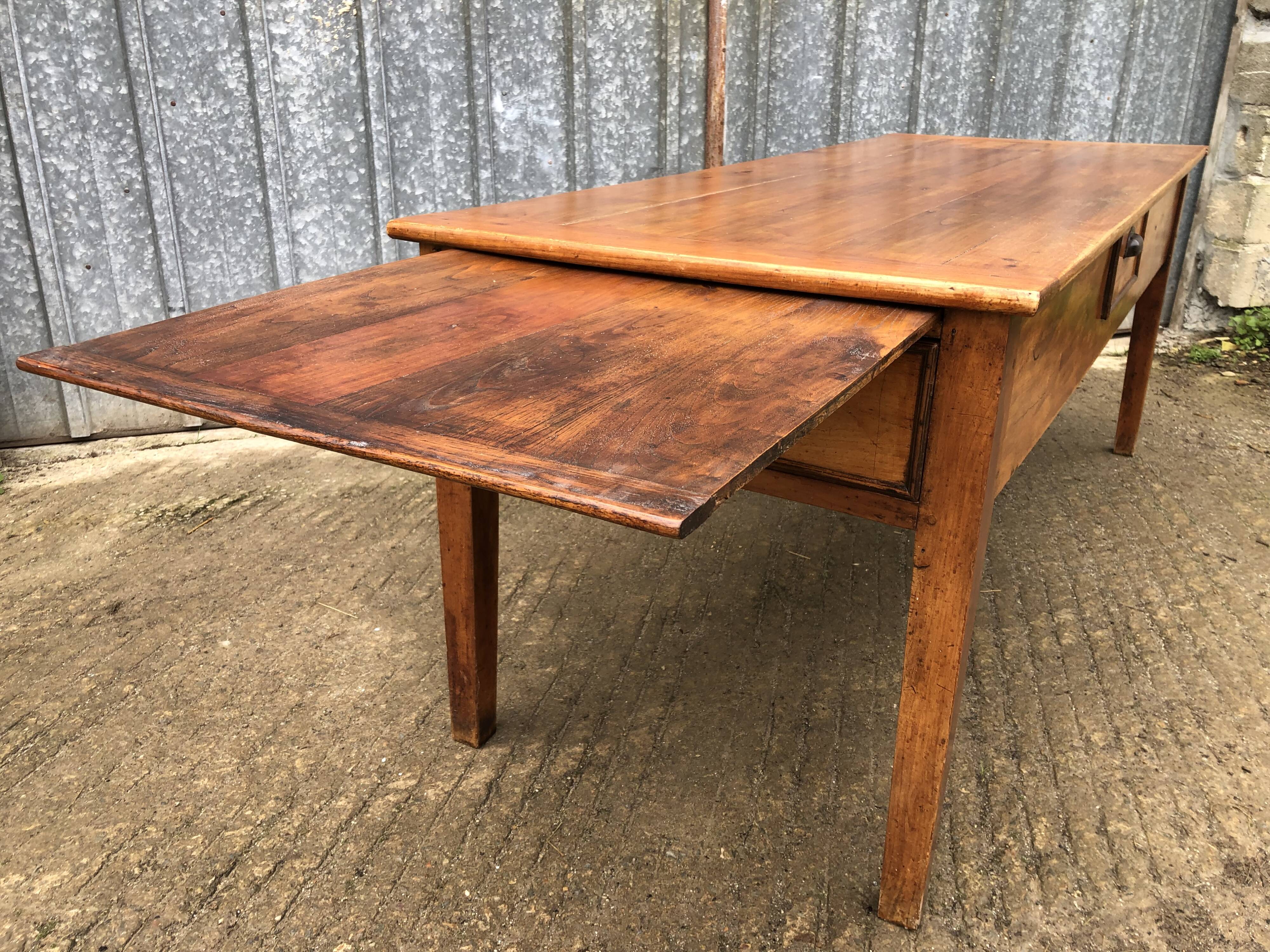 Antique farmhouse table in solid cherry wood with 3 drawers and 1 pull-out.