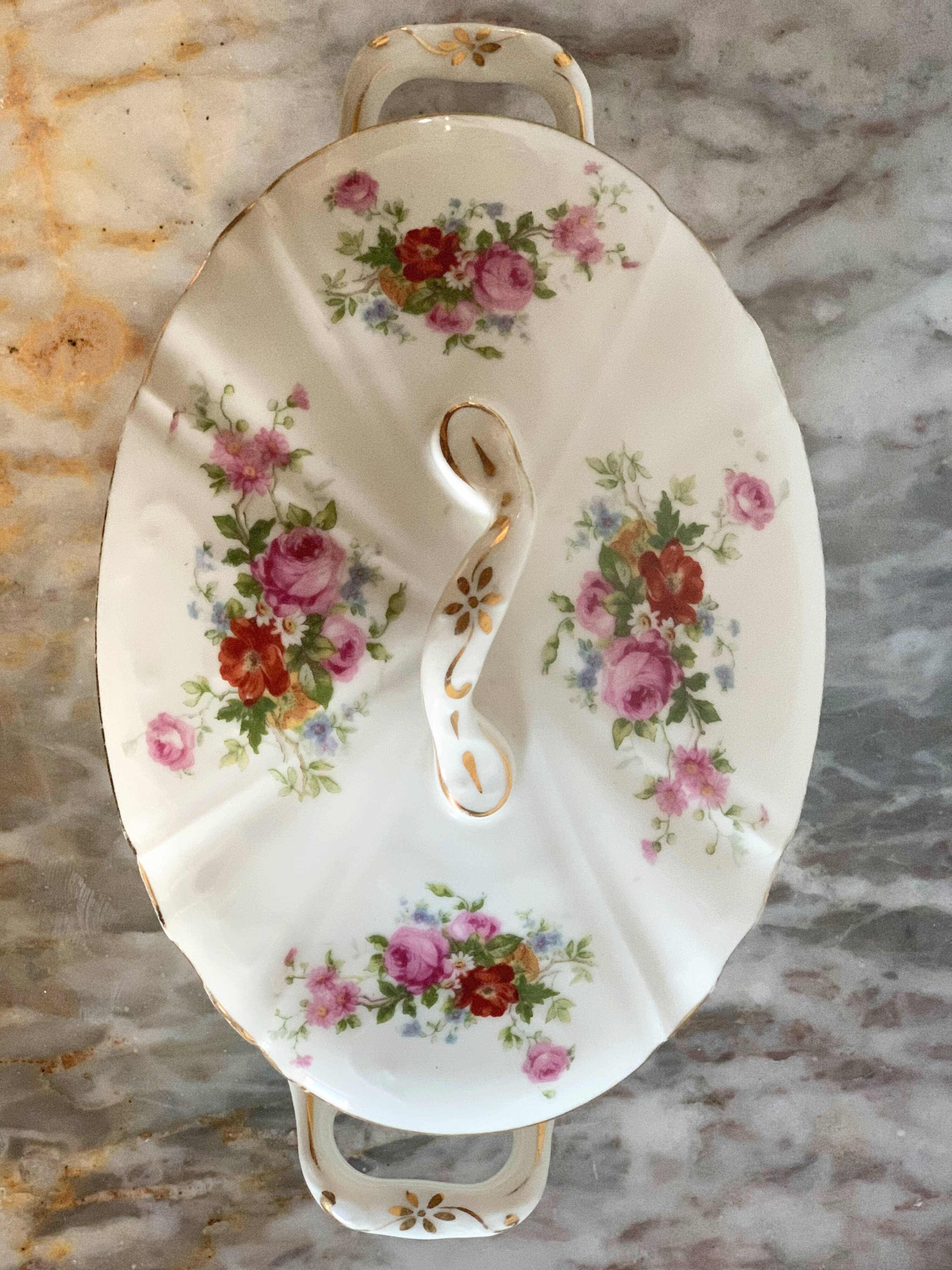 Antique porcelain soup bowl with floral decoration and golden border