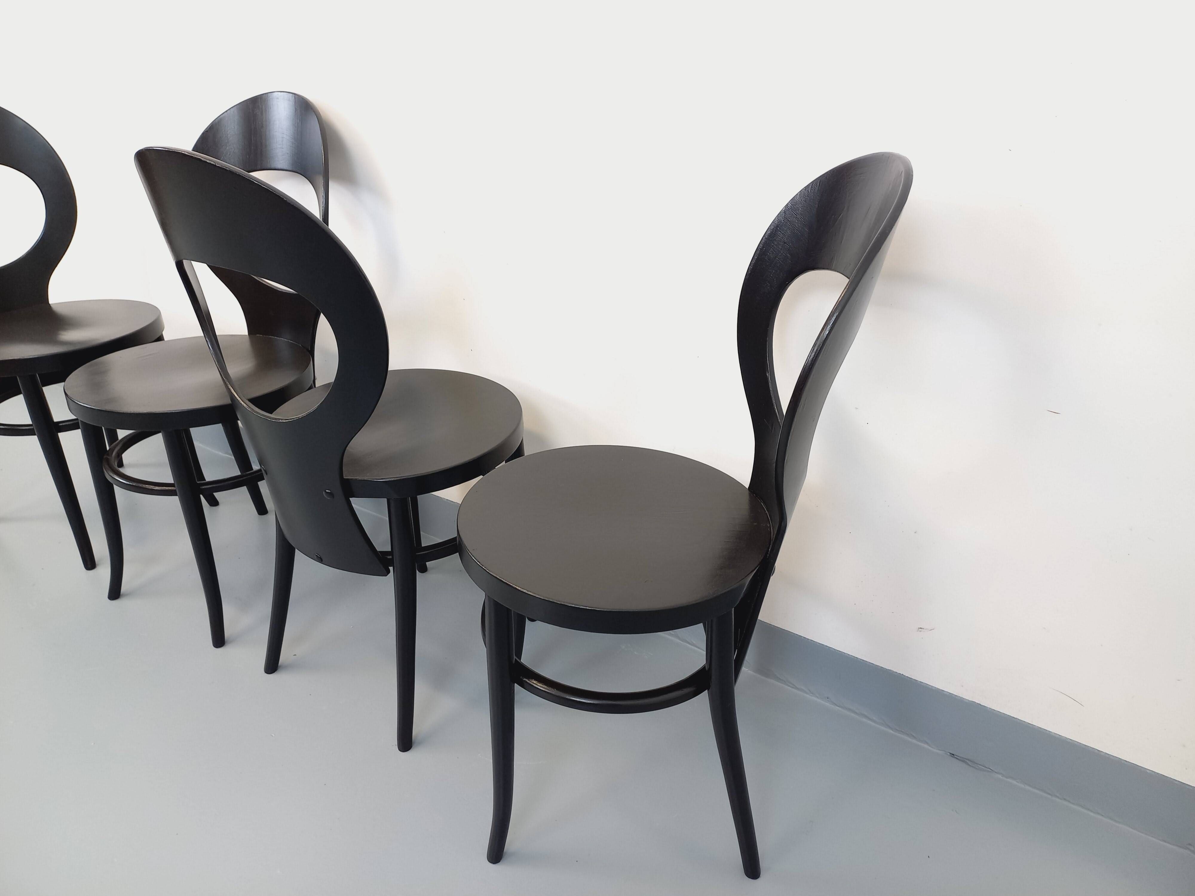 Set of 4 vintage Mouette chairs by Baumann in black wood from the 1960s.