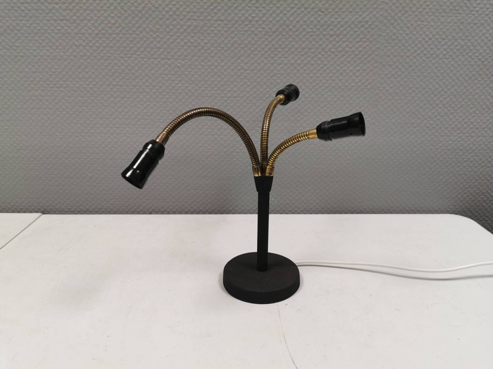Old cast iron table lamp with brass bend and 3 light sources