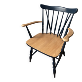 Scandinavian armchair with wooden frame and navy blue upholstery.
