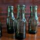 Lot de 5 bouteilles anciennes en verre vert olive