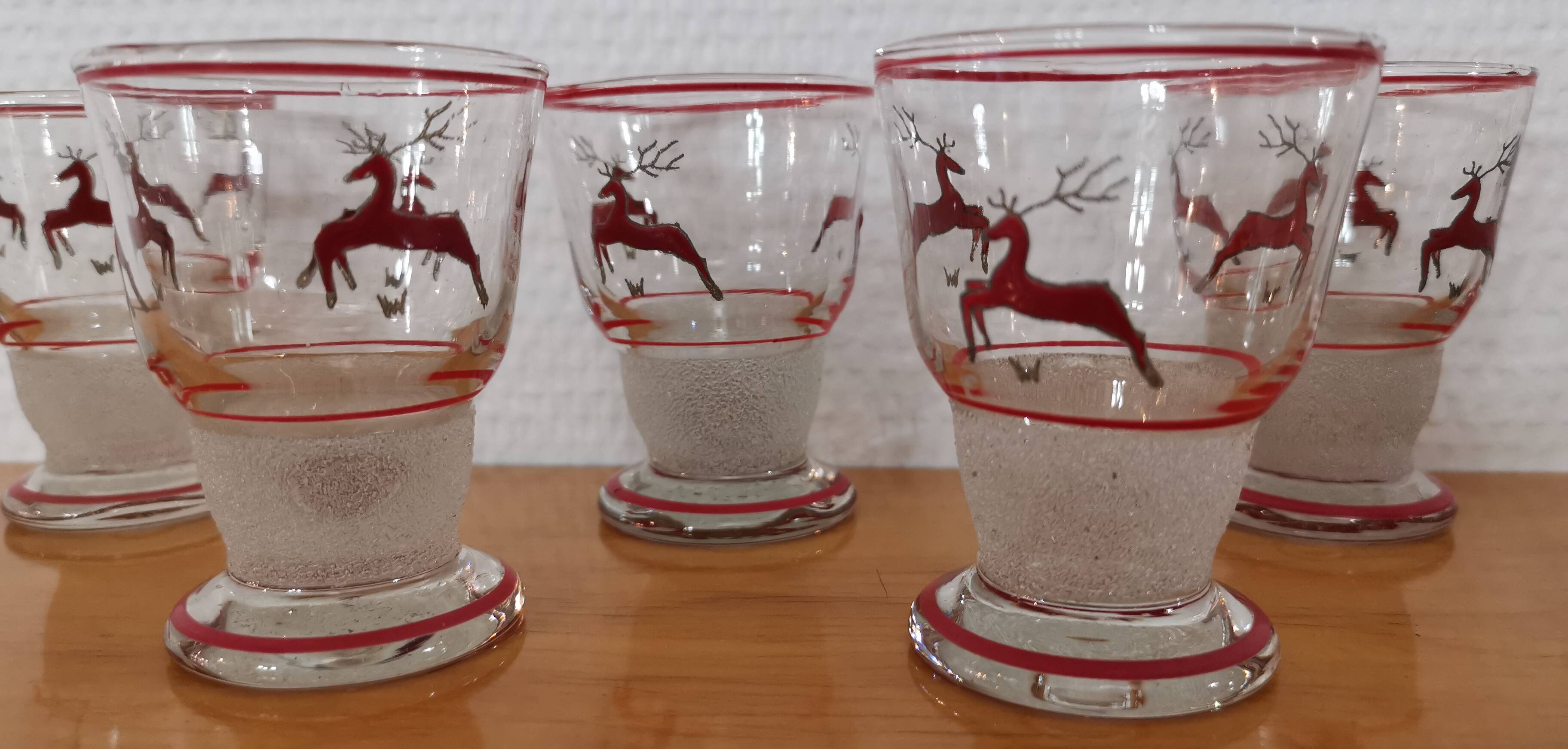 Glasses and carafe decorated with red Christmas reindeer and white granita 60's