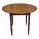 Round kitchen table with extendable leaves in dark wood.