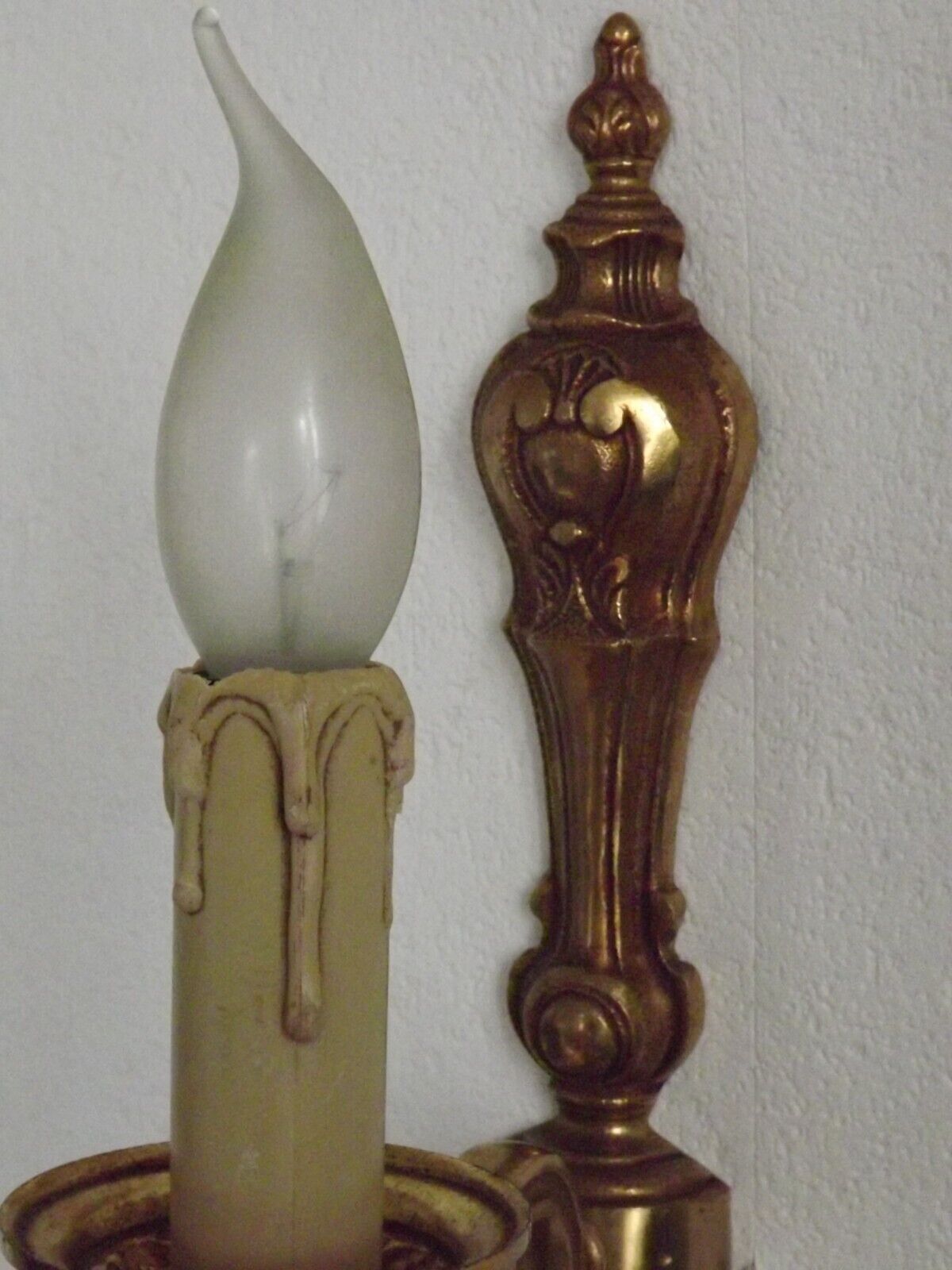 Simple wall sconce in classic Empire style in vintage French bronze.