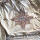 Grey silk nape and towels embroidered with coloured cashmere patterns
