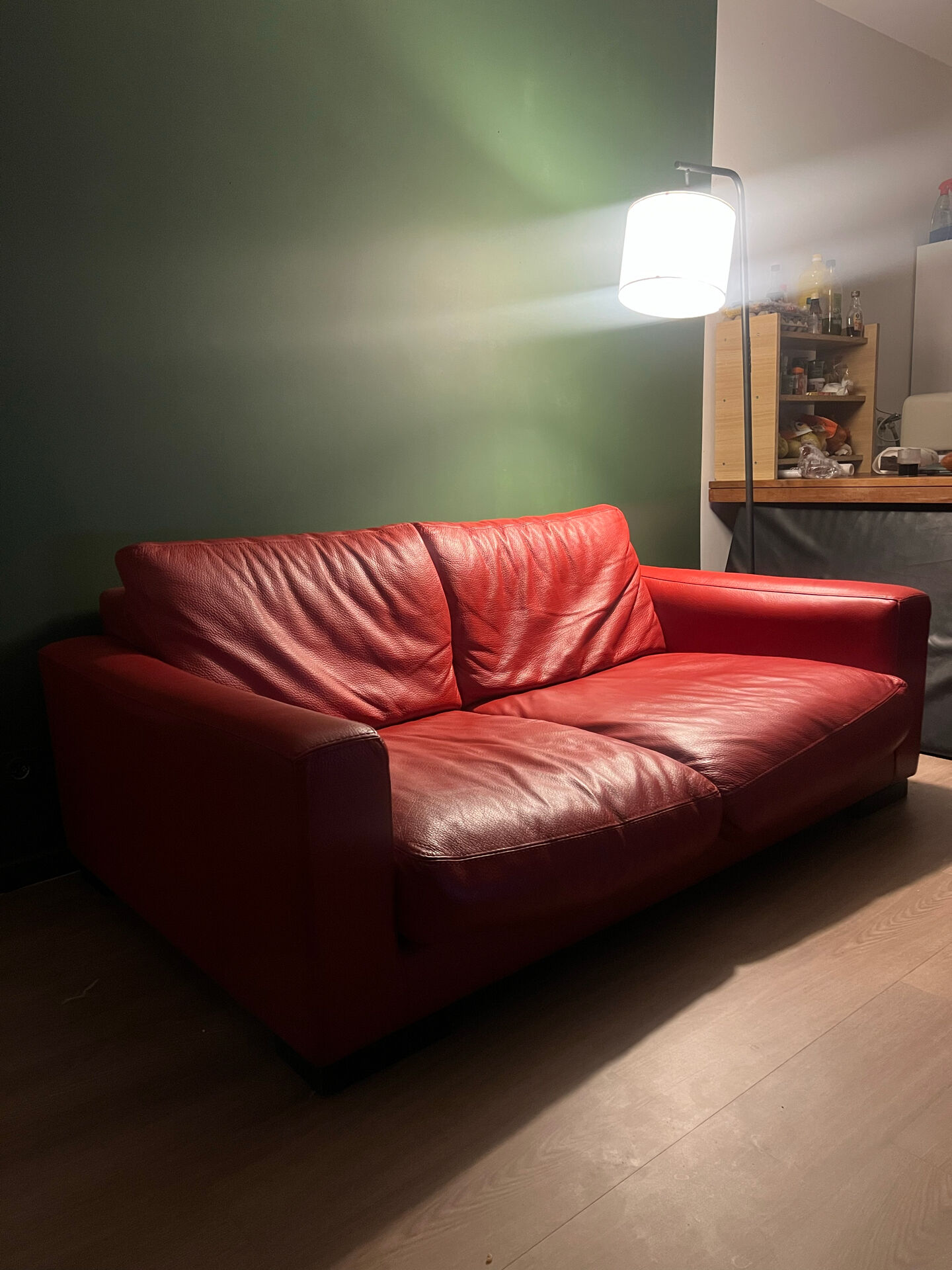 Red leather 2/3-seater sofa by Roche Bobois