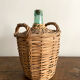 Demijohn surrounded by wicker