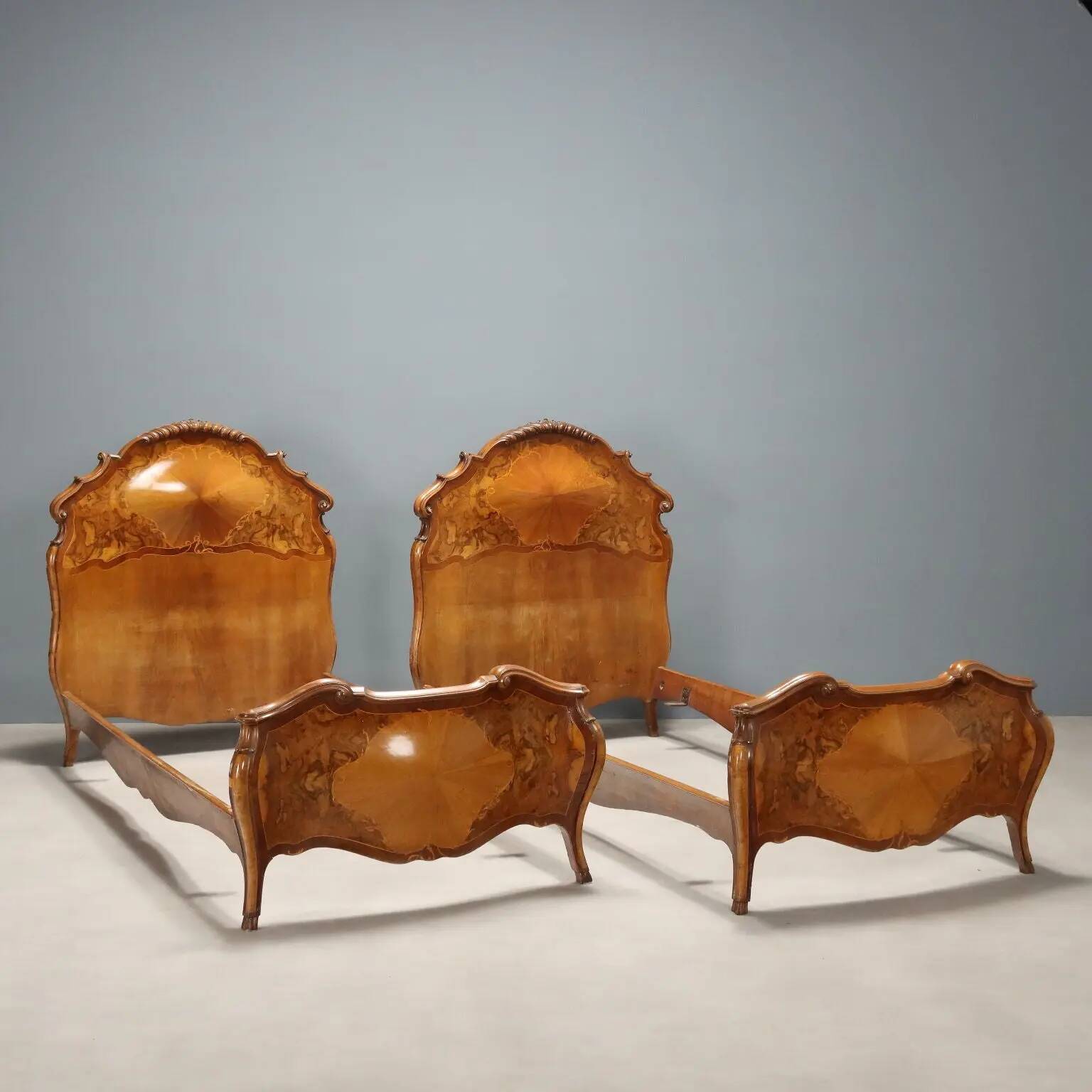 Simple old baroque-style beds in various woods from the 20th century.