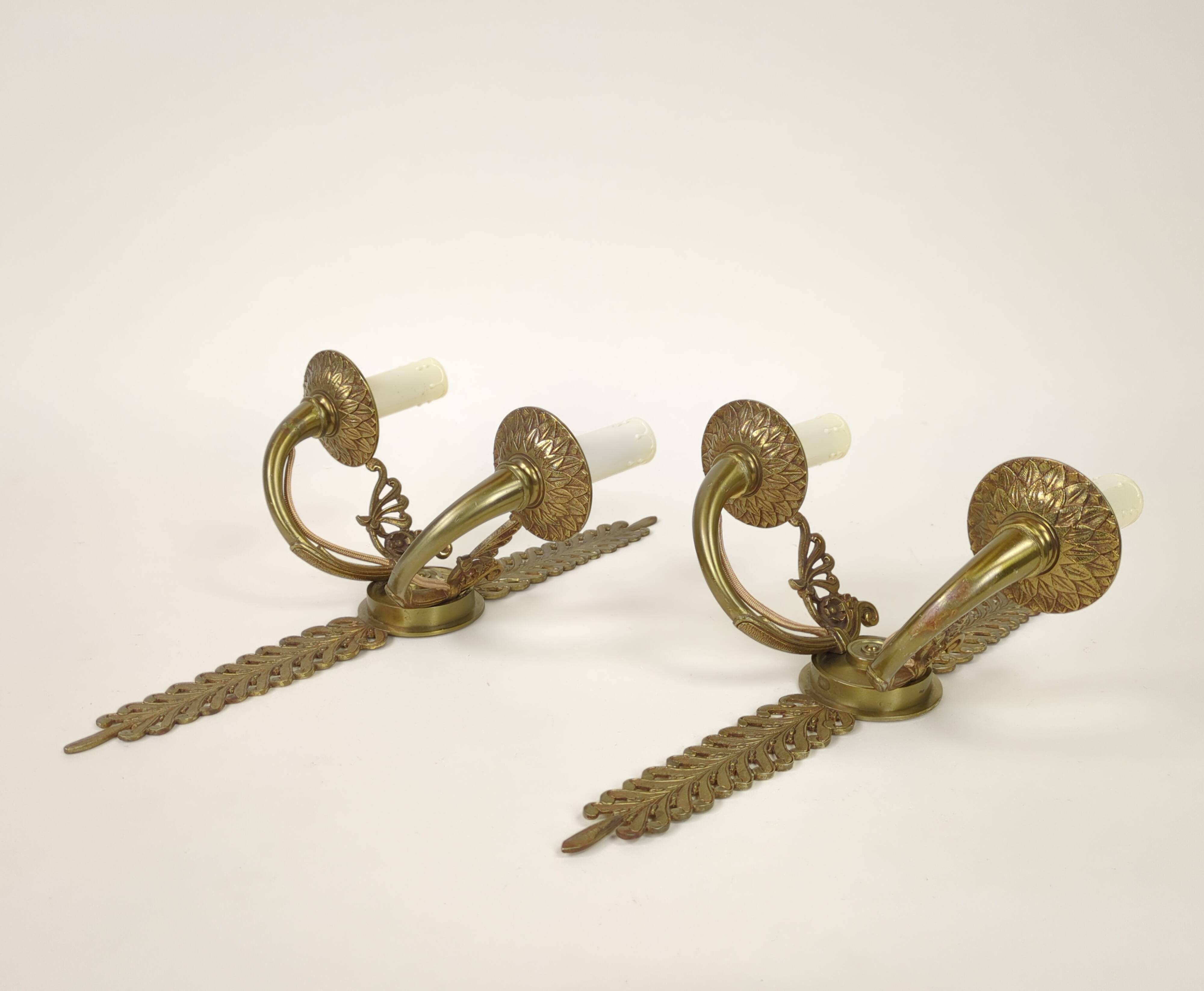Pair of two-armed Empire wall sconces in gilded bronze