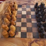 Rustic handmade chessboard made of olive wood
