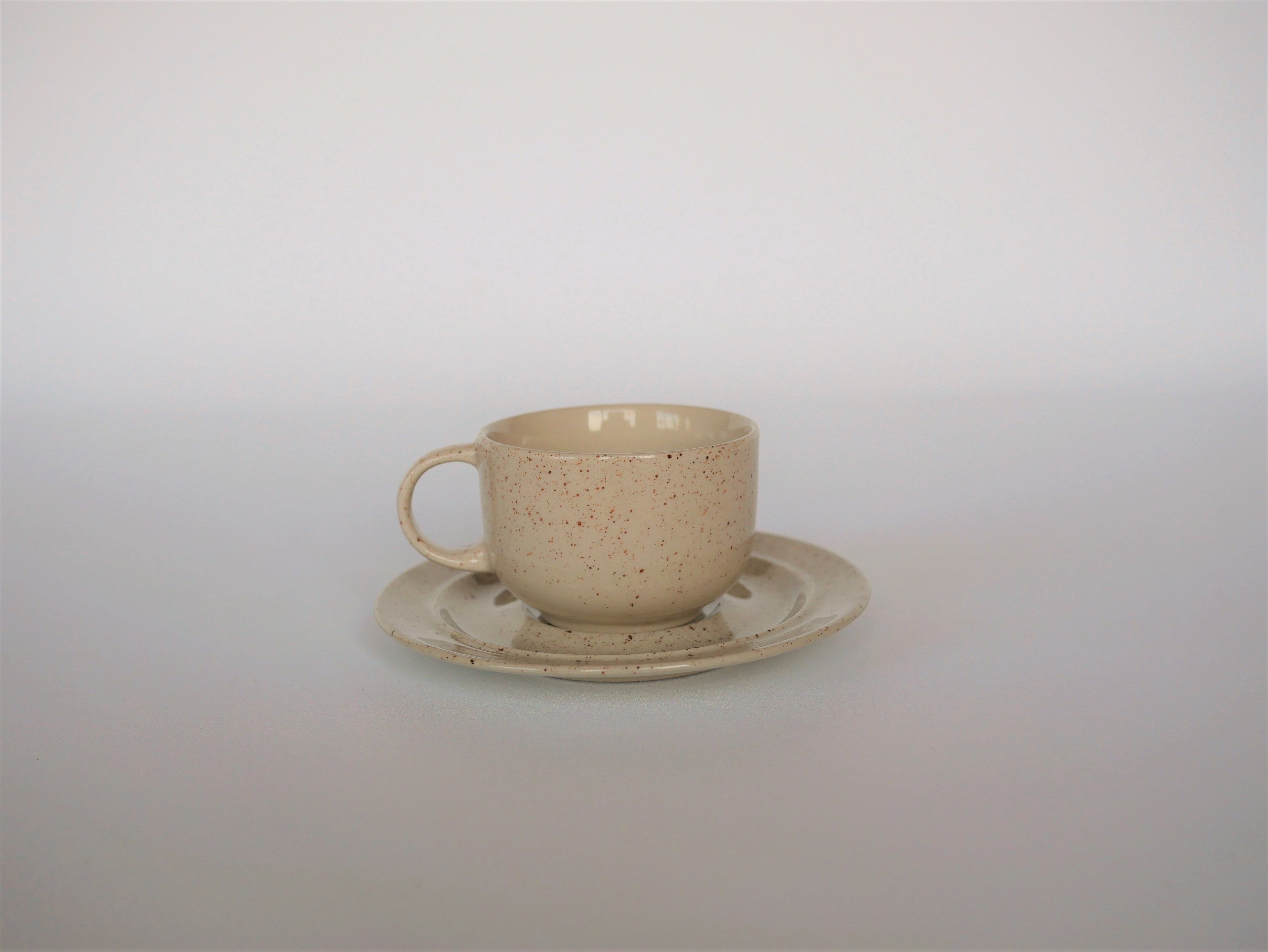 Coffee cup and vintage pyrity sandstone subcup