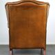 Positively lived-in sheepskin leather wing chair with pleasant seating comfort