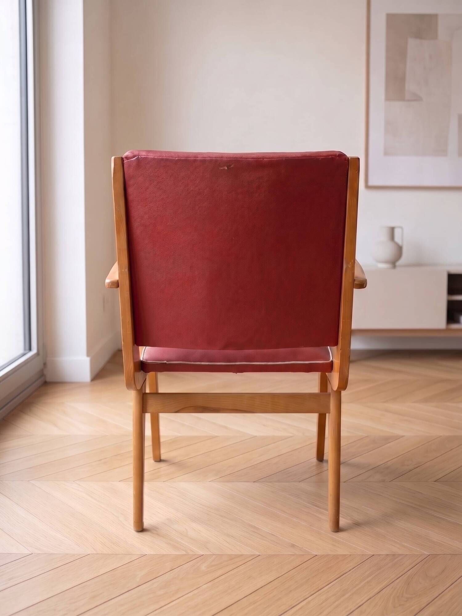 Vintage 1950s armchair in wood and red faux leather.