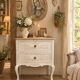 Adorable small chest of drawers or weathered white console.