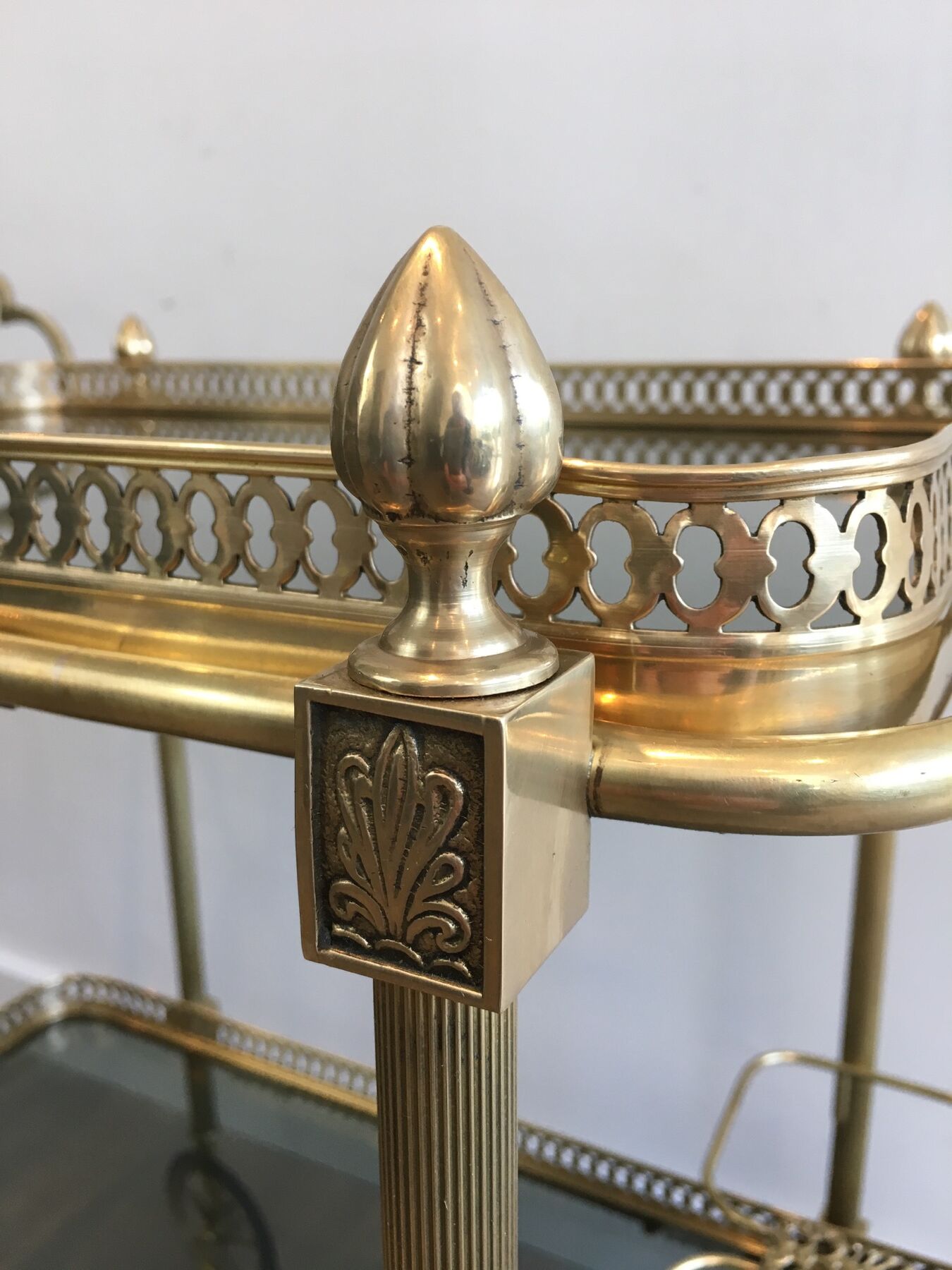 Neoclassical style rolling table in brass with blue glass tops