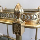 Neoclassical style rolling table in brass with blue glass tops