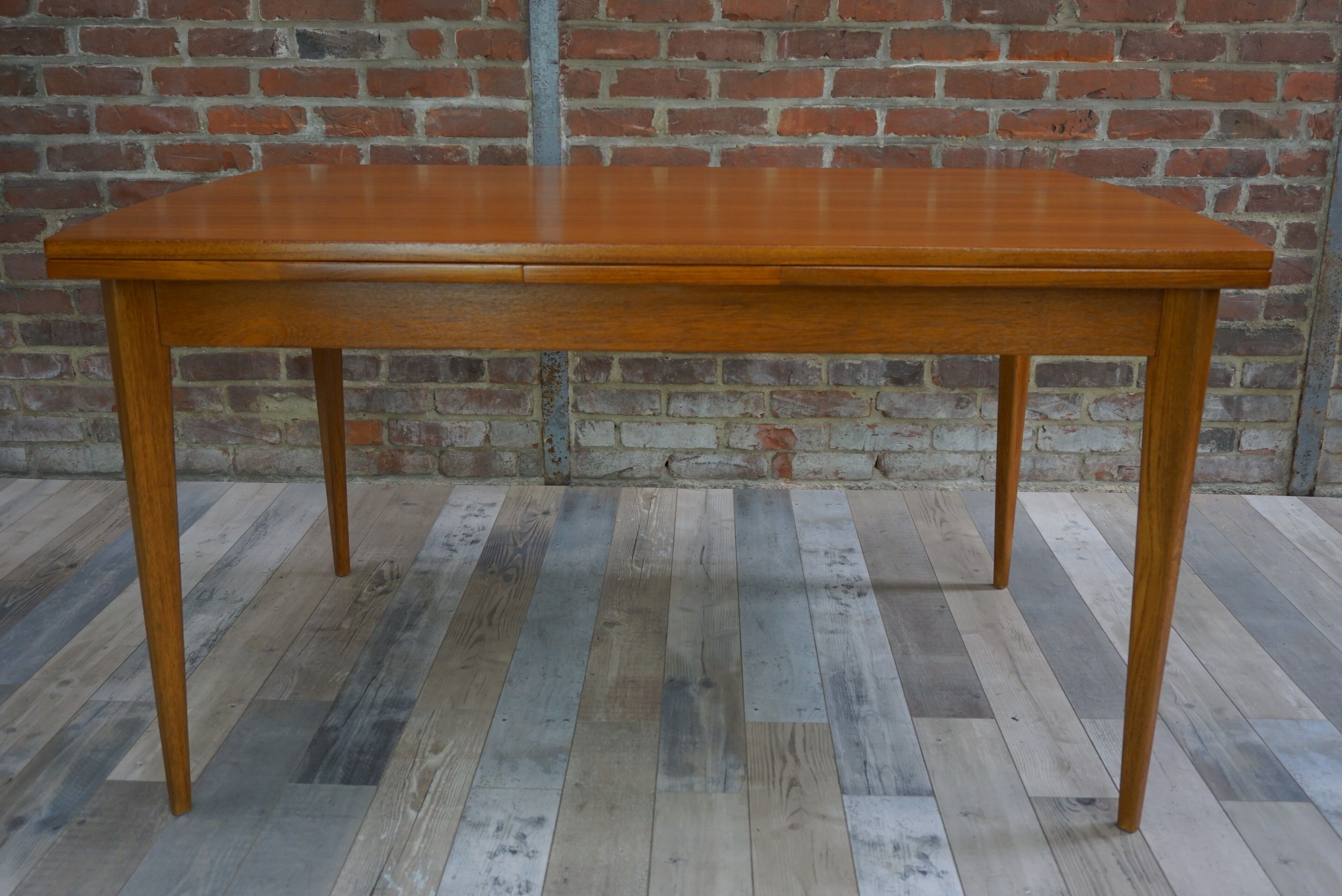 Teak dining table design by Johannes Andersen for Samcom 60s