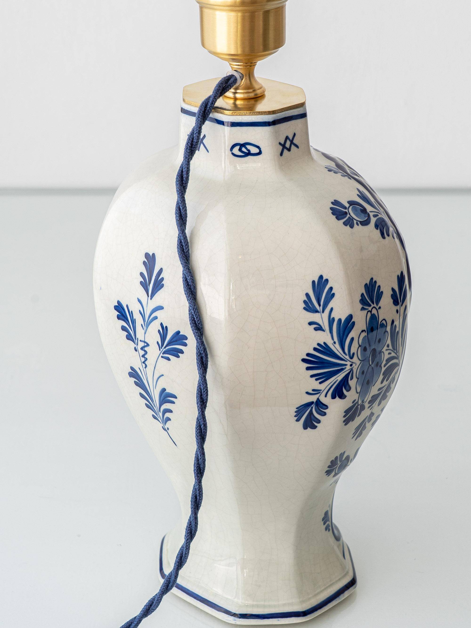 Pair of Royal Delft blue and white ceramic table lamps, 1905, with new pleated silk shades.