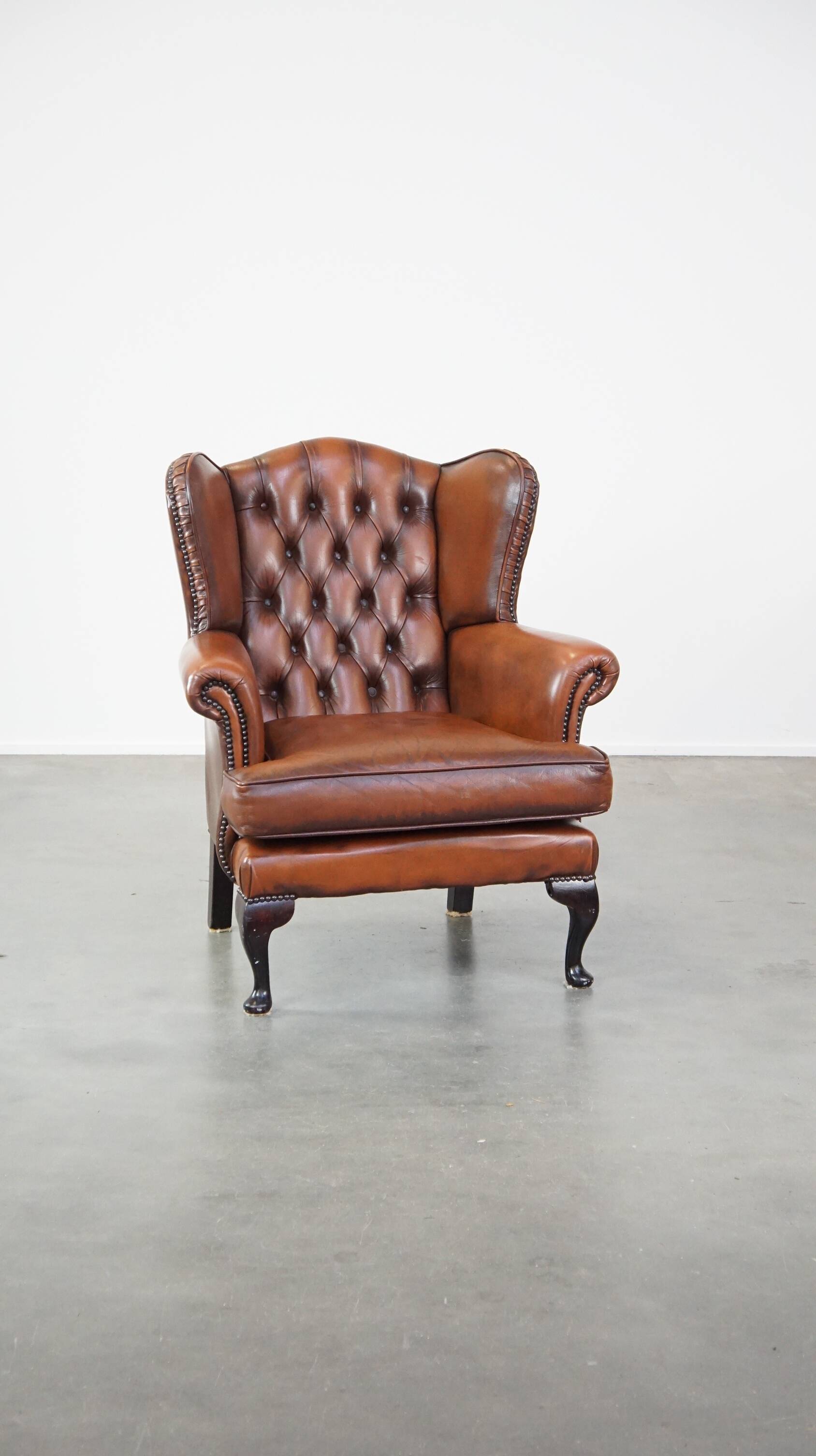 Brown leather wingback Chesterfield armchair