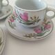 Trio of floral porcelain cups and saucers