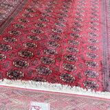 Large red Bokhara-style oriental carpet 300x200 cm with gul patterns.