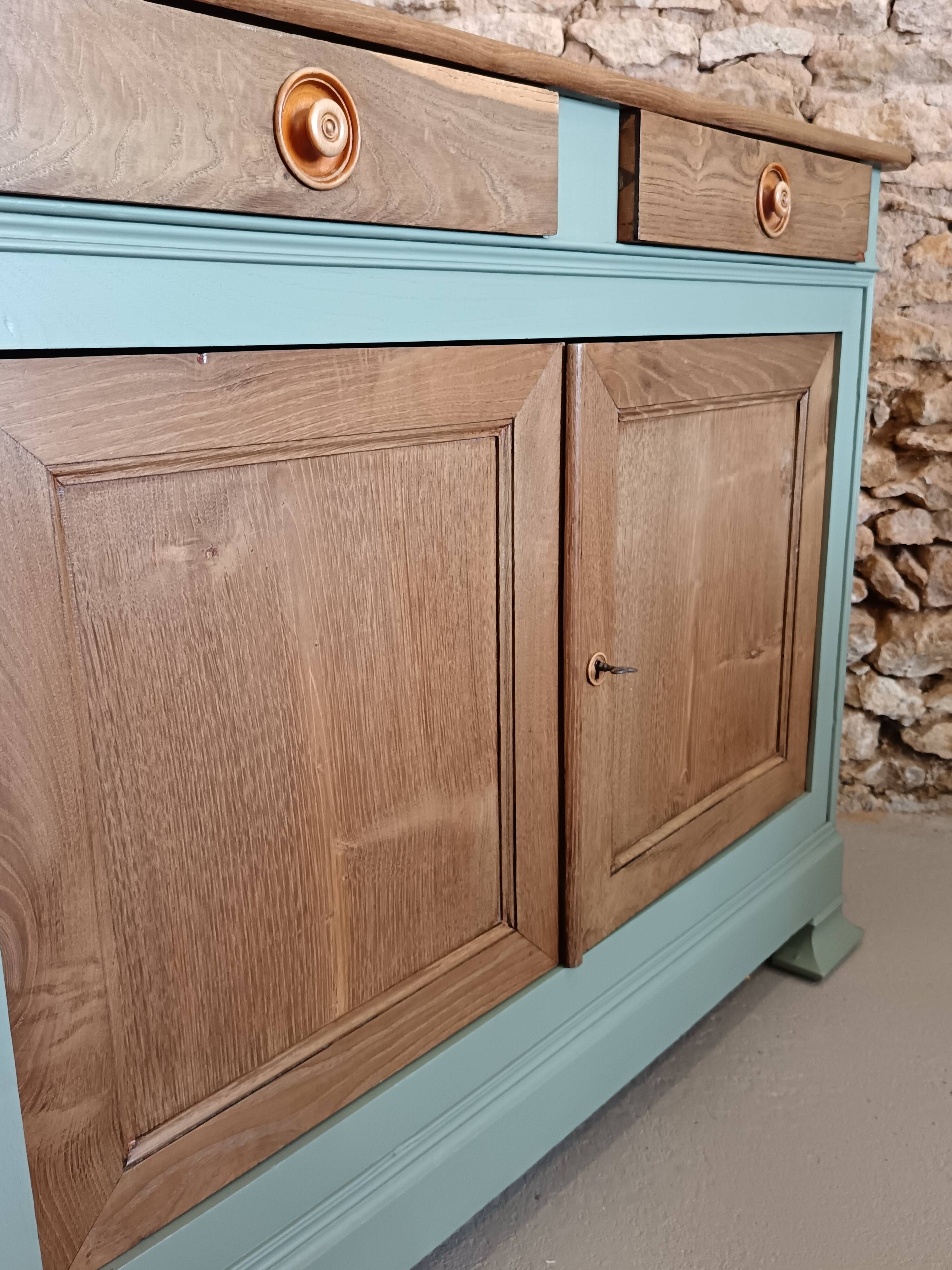 Buffet made of natural wood and bronze green.