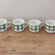 4 vintage cups with green tile decor