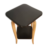 Black lacquered wooden side table with offset tops.