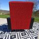 Vintage armchairs in red and black faux leather, the pair.